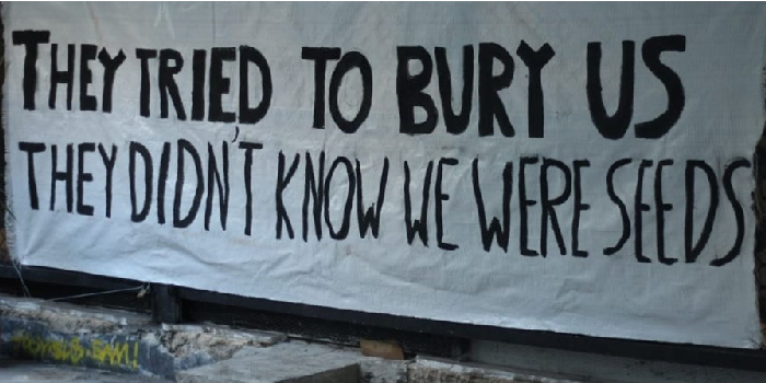 Banner with slogan "The tried to Bury us. They didn't know we were seeds." In solidarity with Exarchia Athens Eviction August 2019